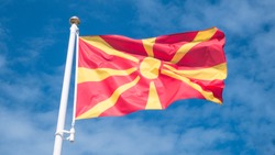 North macedonia flag waving in sunny blue sky.