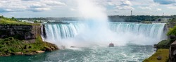 Giant Water Falls with Mist coming of Cruise Ship tourist Ship Niagara Falls on the US Canadian Border in North America