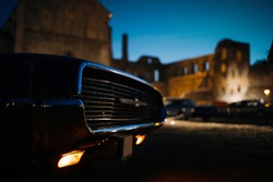 Headlight of old classic car at night