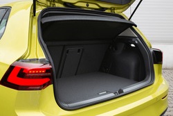 Modern hatchback car with open trunk. The car boot is open for luggage. The car prepared for a drive and waited after the passengers. A lot of space for coffers and bags. Ready for a trip