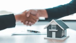 Business success, Real estate agents and customers shake hands to congratulate after signing a contract to buy a house with land and insurance, handshake and Good response concept.