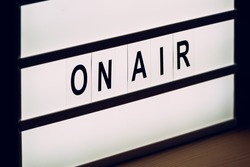Vintage On Air live broadcast sign in radio or television studio blinking
