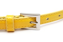 A fasten yellow belt buckle isolated over white background.