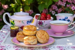 Freshly baked scones with tea served in the garden