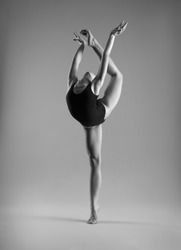 Flexible girl in black bodysuits