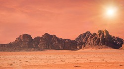 Planet Mars like landscape - Photo of Wadi Rum desert in Jordan with red colour filter and added sun, this location was used as set for many science fiction movies