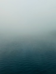 Fog descend on the calm waters of the Volga river creating a moody atmosphere