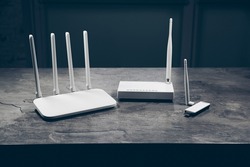 Three different types of Wi-Fi routers, modern and old technology. Wireless ethernet connection signal.