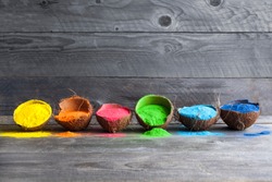 Bright colours in coconut shells for Indian holi festival. Colorful gulal (powder colors) for Happy Holi.