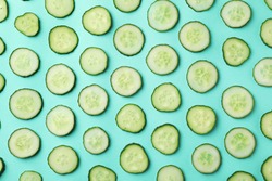 Flat lay composition with slices of cucumber on color background