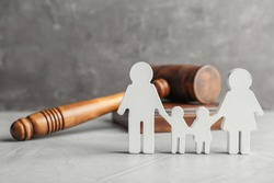 Family figure and gavel on table. Family law concept