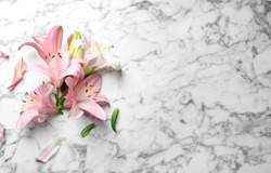 Flat lay composition with lily flowers on marble background