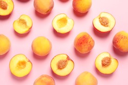 Flat lay composition with ripe peaches on color background