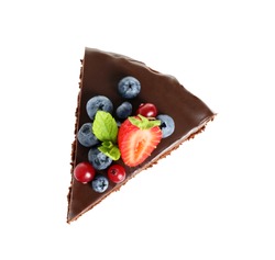 Slice of chocolate sponge cake with berries on white background, top view