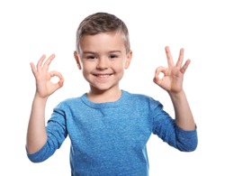 Little boy showing OK gesture in sign language on white background