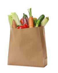 Paper bag with vegetables on white background
