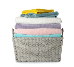 Wicker laundry basket with clean towels on white background