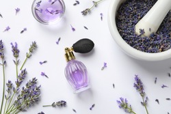 Composition with natural perfume and lavender flowers on white background, top view. Cosmetic product