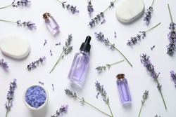 Composition with natural lavender cosmetic products and flowers on white background, top view