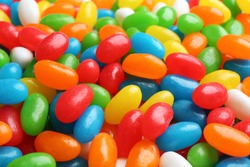 Tasty colorful jelly beans as background, closeup