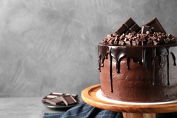 Freshly made delicious chocolate cake on grey background