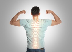Man with healthy back on light background. Spine pain prevention