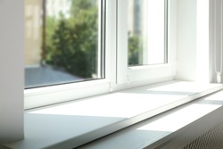Closeup view of window with empty white sill