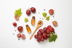 Composition with bottles of natural grape seed oil on white background, top view. Organic cosmetic