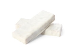 Crunchy granola bars covered with icing on white background