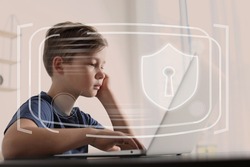 Child safety online. Little boy using laptop at home. Illustration of internet blocking app on foreground