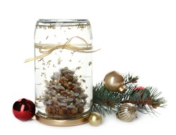 Handmade snow globe with Christmas balls and branch of fir tree on white background