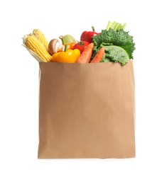 Fresh vegetables in paper shopping bag on white background