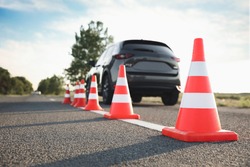 Traffic cones near car outdoors. Driving school exam