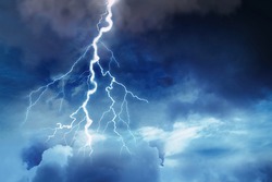 Lightning in dark cloudy sky during thunderstorm