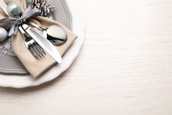 Beautiful Christmas table setting on white wooden background, top view. Space for text