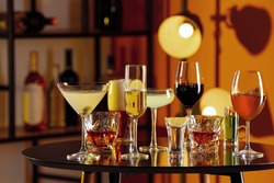 Different alcohol drinks on table in bar