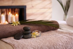 Beautiful spa accessories on massage table in room