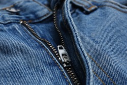 Closeup view of blue jeans with zipper as background