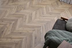 Parquet flooring in living room, above view. Modern material