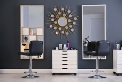 Stylish interior with hairdresser's workplace in beauty salon