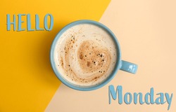 Cup of hot aromatic coffee and phrase Hello Monday on color background, top view