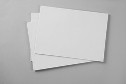 Blank brochures on grey background, top view. Mockup for design