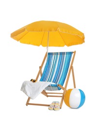 Open yellow beach umbrella, deck chair, inflatable ball and accessories on white background