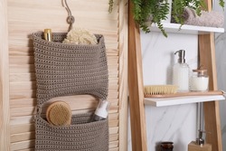 Shelving unit and organizer with essentials in bathroom. Stylish accessory