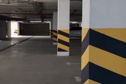 Car parking garage with warning stripes on columns
