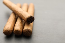 Many cigars on grey table, closeup. Space for text