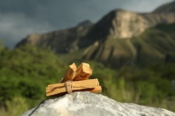 Many palo santo sticks on stone surface in high mountains