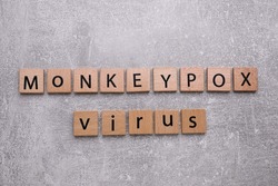 Words Monkeypox Virus made of wooden squares with letters on light grey background, top view
