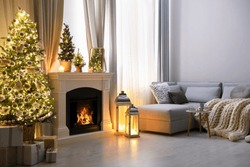 Stylish living room interior with beautiful fireplace, Christmas tree and other decorations