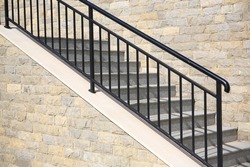 View of beautiful stairs with metal handrail near brick wall outdoors